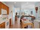 Open kitchen with view to living room, wooden cabinets, and tiled floor at 7934 Kiskadee St, North Las Vegas, NV 89084