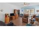 Bright and airy living room featuring tile flooring, a ceiling fan, and a comfortable seating arrangement at 7934 Kiskadee St, North Las Vegas, NV 89084