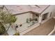 Relaxing covered front porch with cozy seating area, desert landscaping, and a welcoming ambiance at 7934 Kiskadee St, North Las Vegas, NV 89084