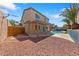 Spacious backyard with a covered patio, pool, palm trees, and decorative privacy wall at 8029 Chablis Bay St, Las Vegas, NV 89131