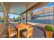 Outdoor dining area on covered patio, adjacent to the sparkling pool and beautifully landscaped backyard at 8029 Chablis Bay St, Las Vegas, NV 89131