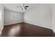Spacious bedroom features wood flooring, a ceiling fan, and a bright window at 8029 Chablis Bay St, Las Vegas, NV 89131