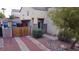 Exterior side view of home with gated driveway and covered patio with blue accents at 8029 Chablis Bay St, Las Vegas, NV 89131
