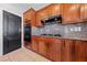 Kitchen area featuring granite counters, wood cabinets, and a black gas cooktop at 8029 Chablis Bay St, Las Vegas, NV 89131