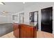 Kitchen area with island and granite countertop, stainless refrigerator, and dark colored door at 8029 Chablis Bay St, Las Vegas, NV 89131