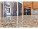 Closeup of granite countertop and stainless steel refrigerator in kitchen at 8029 Chablis Bay St, Las Vegas, NV 89131