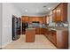 Spacious kitchen featuring a center island, stainless steel appliances, and beautiful wood cabinets at 8029 Chablis Bay St, Las Vegas, NV 89131