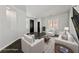 Bright living room featuring neutral decor, white furniture, dark floors, and ample natural light at 8029 Chablis Bay St, Las Vegas, NV 89131