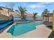 Backyard pool with water feature, blue tile accents, and lush landscaping, perfect for outdoor relaxation at 8029 Chablis Bay St, Las Vegas, NV 89131