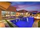 Stunning backyard with a sparkling blue pool, modern pergola, and outdoor seating, perfect for entertaining and relaxation at 819 Bolide St, Las Vegas, NV 89138