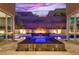 Beautiful backyard showcasing a modern pool, jacuzzi, and water feature, framed by sliding glass doors to the home's interior at 819 Bolide St, Las Vegas, NV 89138