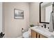 This powder room features a modern vanity with black fixtures at 819 Bolide St, Las Vegas, NV 89138