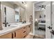 Modern bathroom featuring double sinks, sleek cabinets, and a glimpse of a cozy bedroom in the background at 819 Bolide St, Las Vegas, NV 89138