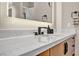 Modern bathroom features a wide mirror, sleek fixtures, and a stylish sink with ample counter space at 819 Bolide St, Las Vegas, NV 89138