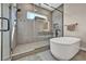 Elegant bathroom featuring a glass-enclosed shower, modern fixtures, and a freestanding tub at 819 Bolide St, Las Vegas, NV 89138