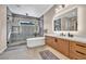 Luxurious bathroom with a modern soaking tub, walk-in shower, and dual vanity sinks at 819 Bolide St, Las Vegas, NV 89138