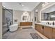 Luxury bathroom featuring dual vanities, a soaking tub, a walk-in shower, and modern fixtures at 819 Bolide St, Las Vegas, NV 89138