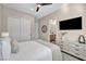 Bedroom with large window for natural light, plush bedding and a modern ceiling fan for added comfort at 819 Bolide St, Las Vegas, NV 89138