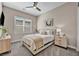 Cozy bedroom features neutral color palette, ceiling fan and plush carpet; ideal for relaxation and comfort at 819 Bolide St, Las Vegas, NV 89138
