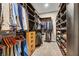 Walk-in closet with custom built-in shelving, drawers, and ample hanging space for clothes and shoes at 819 Bolide St, Las Vegas, NV 89138