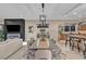 Open dining room and kitchen space features a modern light fixture and seating for eight at 819 Bolide St, Las Vegas, NV 89138