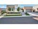 Well-maintained property featuring lush landscaping, an attractive front entrance, and a modern architectural style at 819 Bolide St, Las Vegas, NV 89138