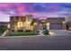 Contemporary home featuring a stone accent wall, manicured landscaping, and a spacious driveway, creating a welcoming curb appeal at 819 Bolide St, Las Vegas, NV 89138