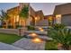 Contemporary home showcasing stone accents, manicured landscaping, and a well-lit entrance, offering curb appeal at 819 Bolide St, Las Vegas, NV 89138