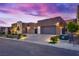 Modern home with a multi-car garage, contemporary design, and stylish landscaping, providing an attractive exterior at 819 Bolide St, Las Vegas, NV 89138