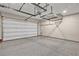 Spacious garage featuring an epoxy floor and overhead storage racks at 819 Bolide St, Las Vegas, NV 89138