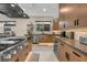 Modern kitchen features stainless steel appliances, dark countertops, and wooden cabinets providing ample storage at 819 Bolide St, Las Vegas, NV 89138