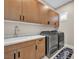 This laundry room offers sleek cabinetry and modern washer and dryer units at 819 Bolide St, Las Vegas, NV 89138