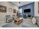 Cozy living room features a blue accent wall and comfortable seating, perfect for relaxation at 819 Bolide St, Las Vegas, NV 89138