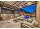 Inviting outdoor kitchen, lounge area and pool featuring a built-in grill and ample seating at 819 Bolide St, Las Vegas, NV 89138
