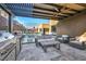 This outdoor kitchen boasts a built-in grill and ample seating near the pool and lounge area at 819 Bolide St, Las Vegas, NV 89138