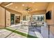 Spacious covered patio with outdoor dining set and view into the kitchen and dining room through large windows at 819 Bolide St, Las Vegas, NV 89138