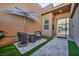 Relaxing outdoor patio area featuring a comfortable seating arrangement and shade umbrella at 819 Bolide St, Las Vegas, NV 89138