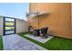 Relaxing outdoor patio area featuring a comfortable seating arrangement and shade umbrella at 819 Bolide St, Las Vegas, NV 89138