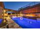 This backyard boasts a beautiful pool and fire feature under a covered patio at 819 Bolide St, Las Vegas, NV 89138