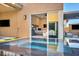Tranquil, refreshing view of a small jacuzzi with a glimpse into a modern bedroom with king bed and neutral colors at 819 Bolide St, Las Vegas, NV 89138