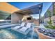 Luxury swimming pool with a sun shelf, two lounge chairs and outdoor kitchen with grill at 819 Bolide St, Las Vegas, NV 89138