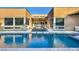 Beautiful backyard with a large in-ground swimming pool, hot tub, and covered patio for relaxing and entertaining at 819 Bolide St, Las Vegas, NV 89138