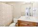 Standard bathroom featuring a mirror, sink and vanity with a shower behind a curtain at 8255 Las Vegas Blvd # 713, Las Vegas, NV 89123