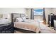 Comfortable bedroom featuring a large bed, bedside tables, and sliding doors to a balcony with a view at 8255 Las Vegas Blvd # 713, Las Vegas, NV 89123