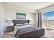 Relaxing bedroom with a large bed, bedside tables, a picturesque painting, and view from the balcony at 8255 Las Vegas Blvd # 713, Las Vegas, NV 89123