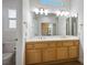Bright bathroom features dual sinks, a large mirror, and access to a closet at 8901 Kingsmill Dr, Las Vegas, NV 89134