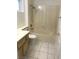 Bathroom showcasing a tub-shower combination and a single vanity with tiled floors, designed for practicality at 8901 Kingsmill Dr, Las Vegas, NV 89134