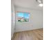 Cozy bedroom with wood floors, ceiling fan, and a sunny window view at 8901 Kingsmill Dr, Las Vegas, NV 89134