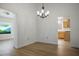 Bright dining room with wood floors, contemporary chandelier, and view into the kitchen at 8901 Kingsmill Dr, Las Vegas, NV 89134