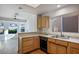 Well-lit kitchen featuring wood cabinets, light countertops, and modern appliances at 8901 Kingsmill Dr, Las Vegas, NV 89134